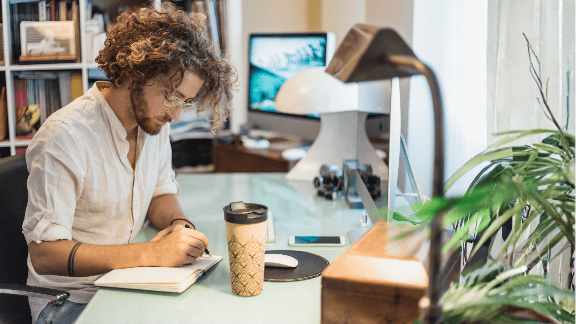 Creator reviewing notes at a desk before year-end, using a tax checklist to organize finances, expenses, and records for tax season.